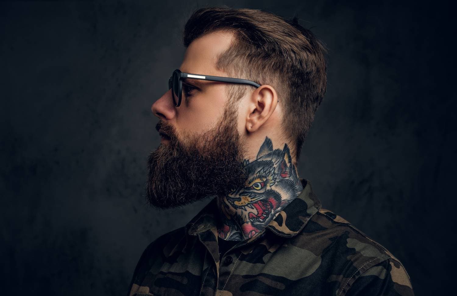 Bearded man wearing sunglasses and tattoo